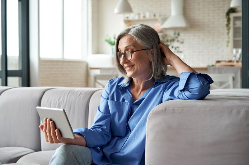 Middle-aged woman exploring no medical life insurance coverage on tablet