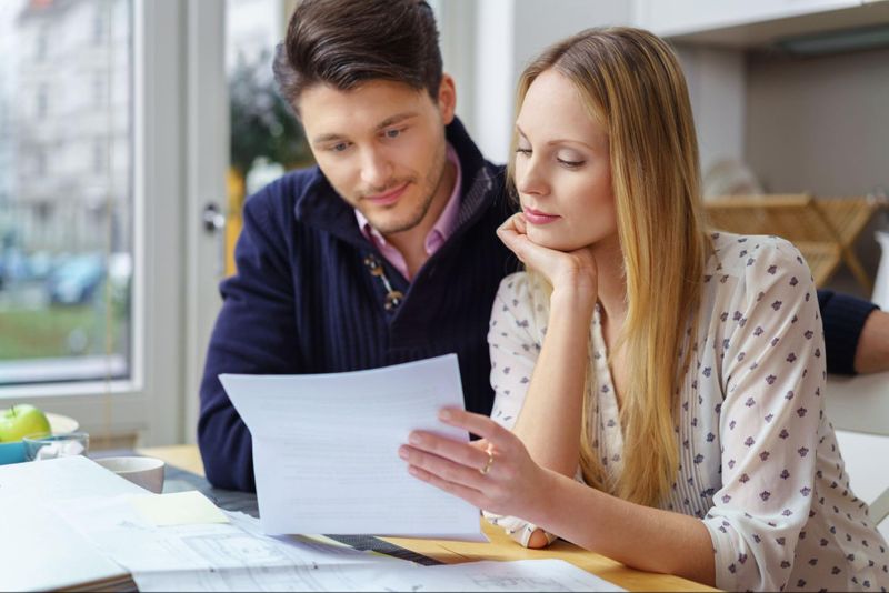 Younger couple looking at their life insurance policy.