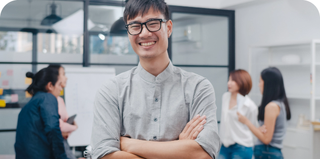 Smiling employee with glasses posing during team meeting