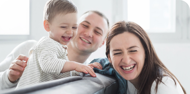 Family of three goofing around in BC living room