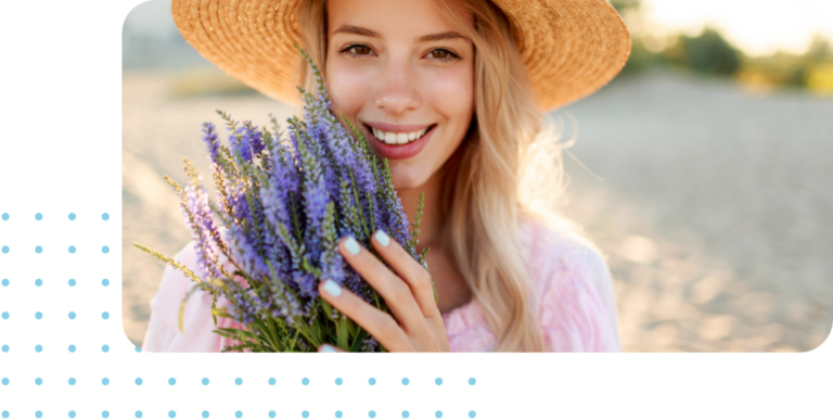 Smiling young woman in sun hat holding a bushel of BC lavender