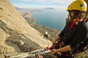 Insured rock climbers ascending coastal mountain in BC