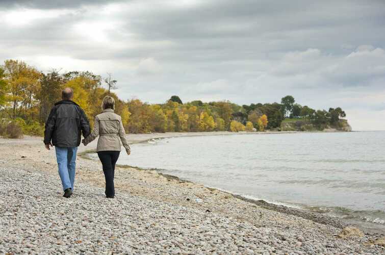 people walking down a beach