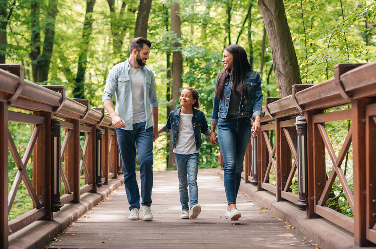 a family walking over a bridge
